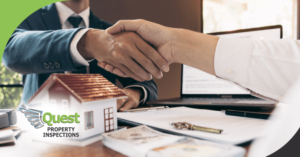 Agents shaking hands over home inspection documents