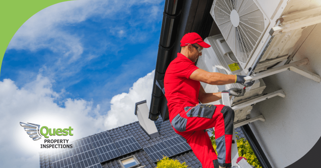 Technician on ladder adjusting wall air conditioner