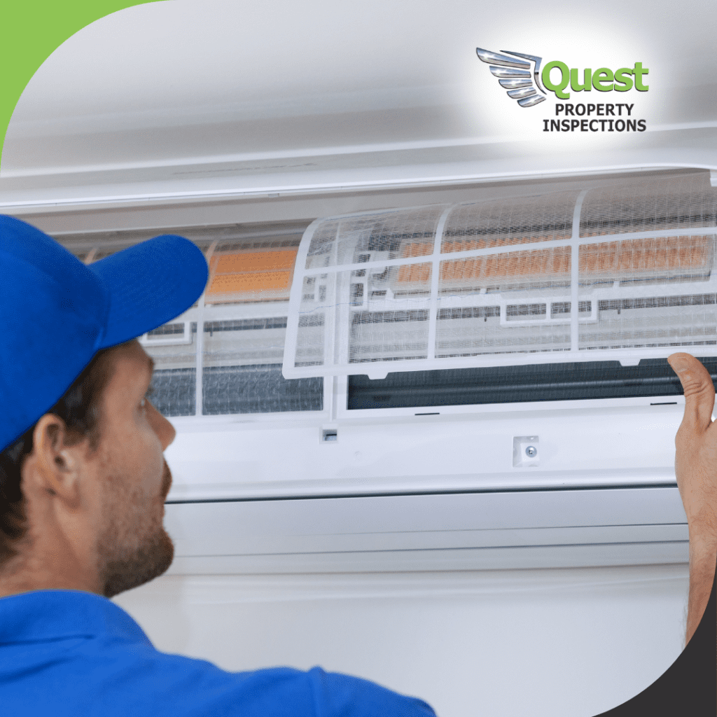 Worker removing wall-mounted AC filter cover