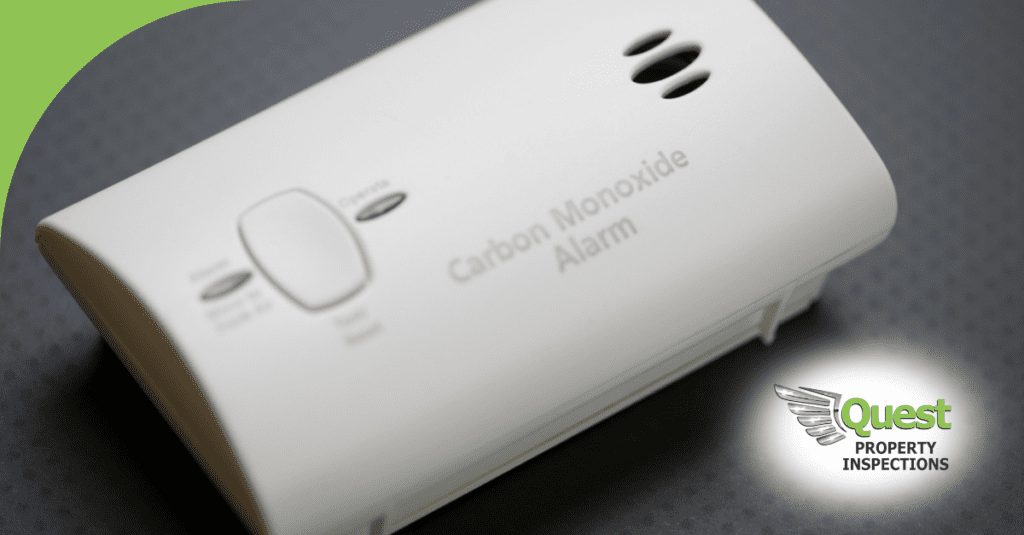White carbon monoxide detector with Quest logo