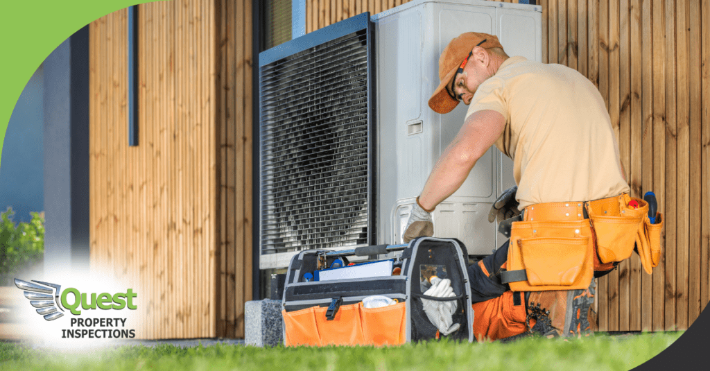 HVAC worker kneeling by condenser with tools