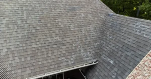Hail-damaged asphalt shingle roof with chalk markings identifying impact spots