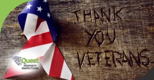 Wooden background with an American flag ribbon and 'Thank You Veterans' engraved